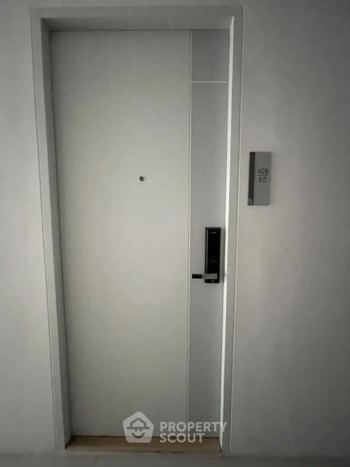 Modern apartment entrance with sleek door and digital lock