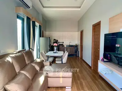 Modern living room with open kitchen layout and stylish furniture