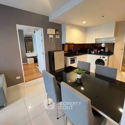 Modern open-plan kitchen and dining area with sleek design and stylish furniture.