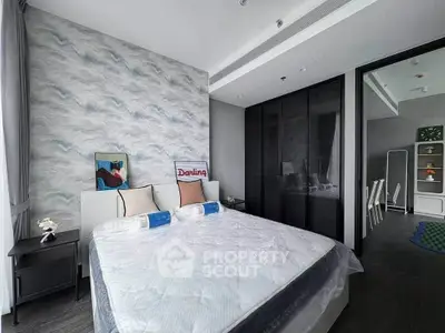 Modern bedroom with stylish decor and large bed in contemporary apartment.