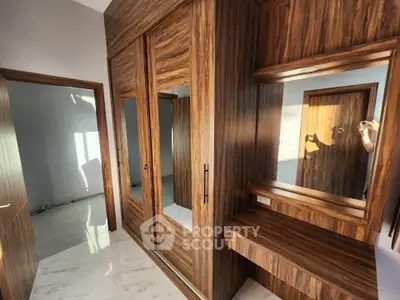 Luxurious wooden wardrobe with mirror in modern bedroom interior