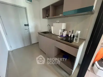 Modern compact kitchen with sleek cabinetry and built-in appliances, perfect for urban living.