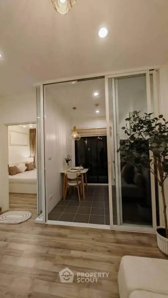 Modern open-plan living room with dining area and cozy bedroom view
