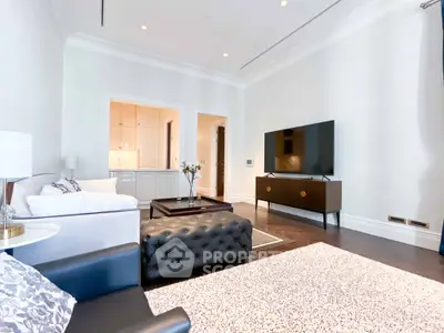 Luxurious living room with modern decor and large TV, perfect for relaxation.