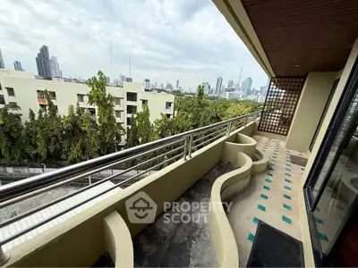 Spacious balcony with city skyline view and unique railing design
