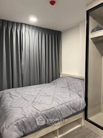 Cozy bedroom with modern design and ample closet space, perfect for comfortable living.