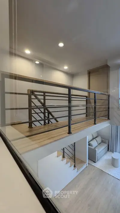 Modern duplex interior with sleek staircase and cozy living area