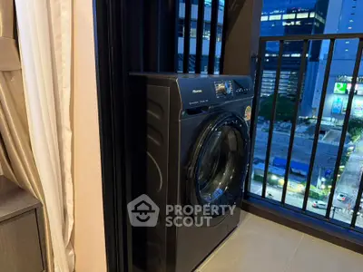 Modern apartment balcony with washing machine and city view
