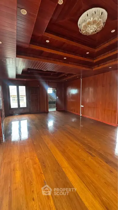 Spacious wooden interior with elegant ceiling design and polished floors