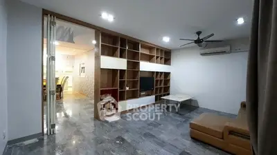 Spacious modern living room with built-in shelving and open layout