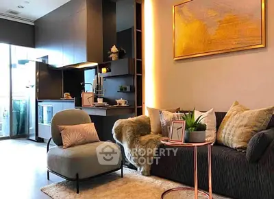 Modern living room with stylish decor and open kitchen layout, featuring cozy seating and elegant lighting.