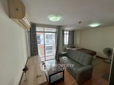Cozy living room with modern furniture and large windows in a stylish apartment.