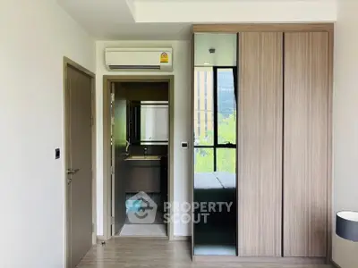 Modern bedroom with sleek wardrobe and air conditioning unit