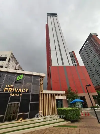 Modern high-rise building with sleek design at The Privacy Rama 9, showcasing urban living in Bangkok.