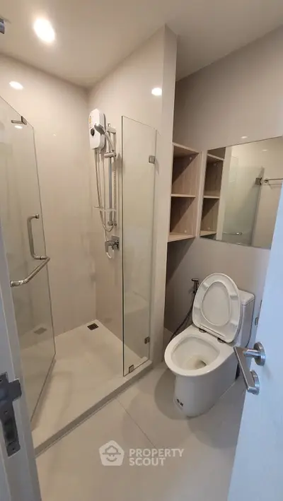 Modern bathroom with glass shower and sleek fixtures