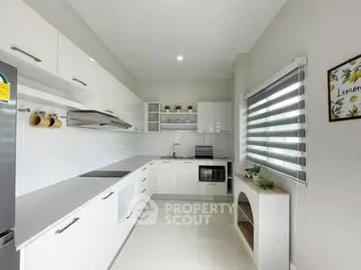 Modern kitchen with sleek white cabinetry and open layout design