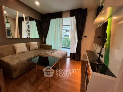 Modern living room with stylish decor and large windows overlooking greenery.
