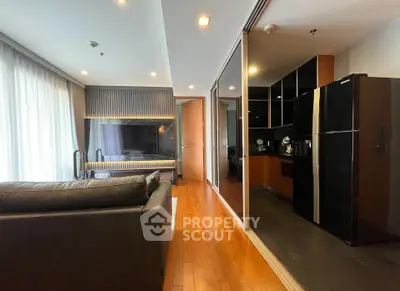 Modern open-layout living room with sleek kitchen and stylish decor
