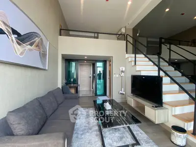 Modern duplex living room with stylish decor and open staircase