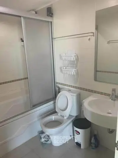 Modern bathroom with shower and toilet in a clean, minimalist design.
