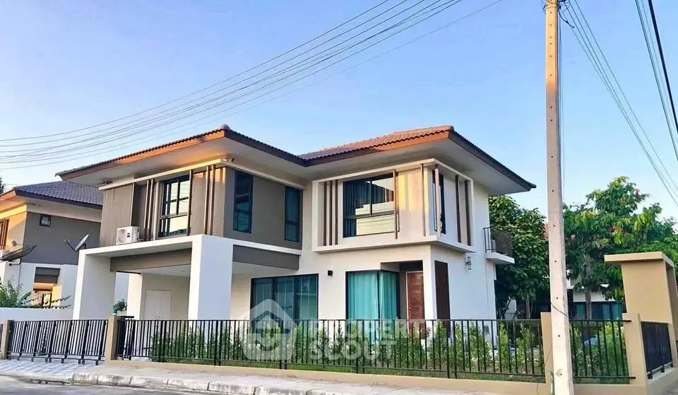 Modern two-story house with sleek design and large windows, perfect for family living.