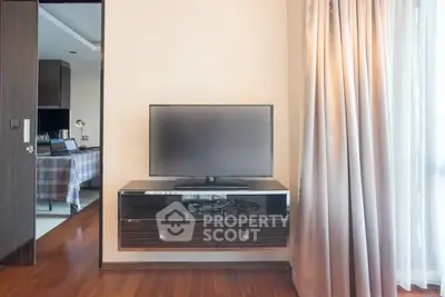Modern living room with sleek TV setup and elegant curtains