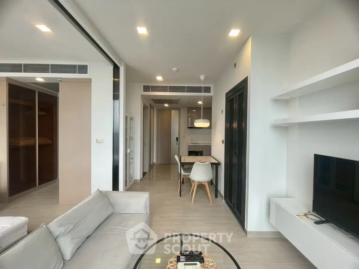 Modern open-plan living room with sleek furniture and natural light