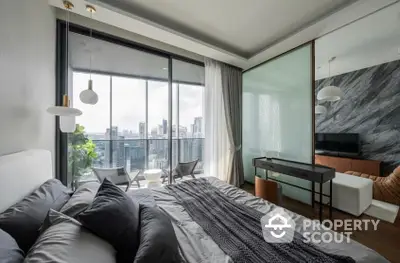 Luxurious bedroom with floor-to-ceiling windows offering a panoramic city view, complemented by a modern design and chic furnishings.