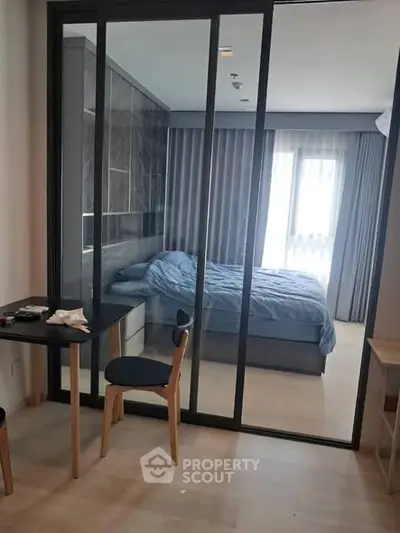 Modern bedroom with glass sliding doors and cozy decor