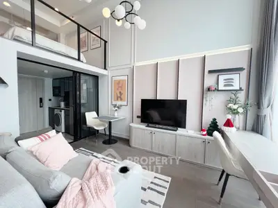 Modern loft apartment with stylish decor and open layout, featuring a cozy living area and mezzanine bedroom.
