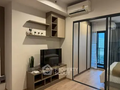 Modern bedroom with sliding glass door and stylish TV unit