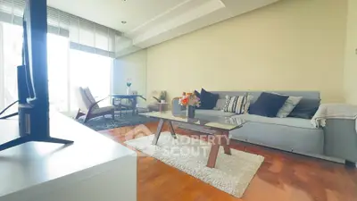 Spacious living room with modern decor and large windows offering natural light.