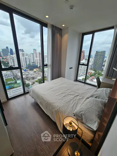 Modern bedroom with stunning city view and floor-to-ceiling windows