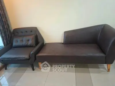 Stylish modern living room with sleek leather sofa and armchair, perfect for contemporary interiors.