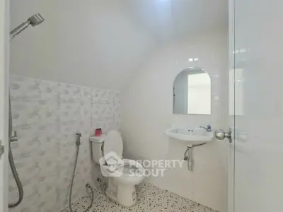 Modern bathroom with sleek white tiles and contemporary fixtures