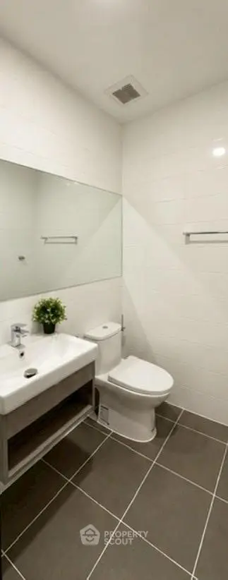 Modern bathroom with sleek fixtures and elegant tile design, perfect for contemporary living.