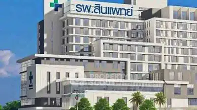 Modern hospital building with contemporary architecture and lush landscaping.