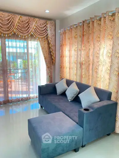 Charming living room with elegant curtains and cozy blue sofa set