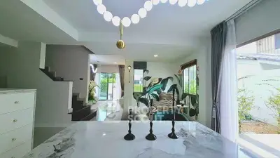 Modern open-plan living area with stylish decor and natural light