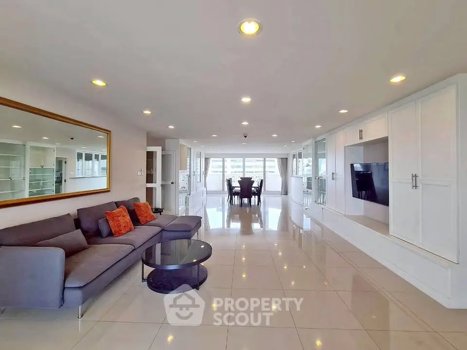 Spacious modern living room with sleek design and large windows offering abundant natural light.