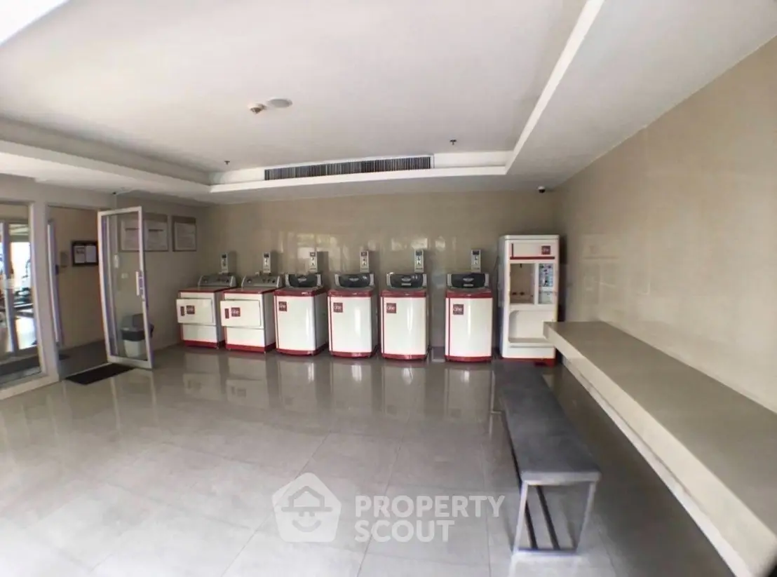 Modern laundry room with multiple washing machines in a residential building.