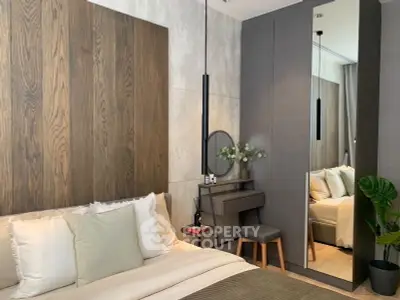 Modern bedroom with stylish decor and mirrored wardrobe