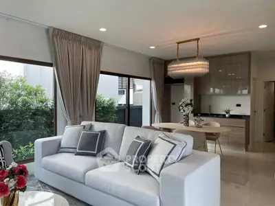 Modern living room with elegant decor and open kitchen layout