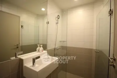 Modern bathroom with glass shower and sleek sink design
