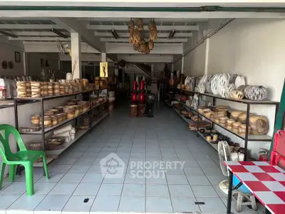 Spacious retail space with tiled flooring and ample shelving for display