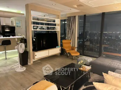 Luxurious modern living room with city view, stylish furniture, and open kitchen layout.