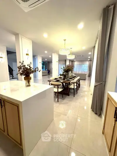 Luxurious open-plan dining area with elegant lighting and modern decor