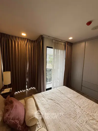Cozy bedroom with elegant curtains and natural light, featuring a comfortable bed and stylish decor.