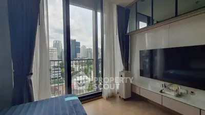 Modern bedroom with city view and large windows in high-rise apartment