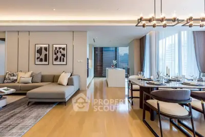 Luxurious open-plan living and dining area with modern decor and elegant lighting.